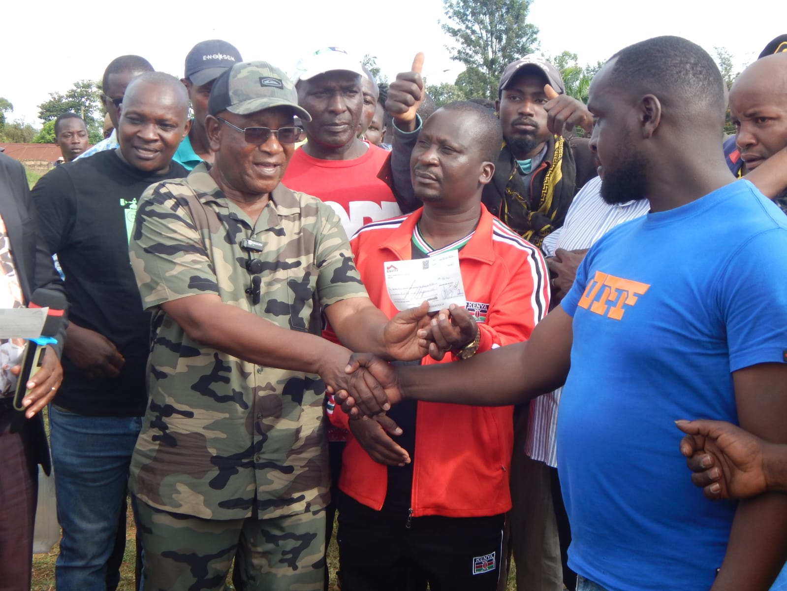 South Imenti MP Dr. Shadrach Mwiti (in jungle uniform) when he presented cheques to boda boda riders in Nkubu town to empower them economically.